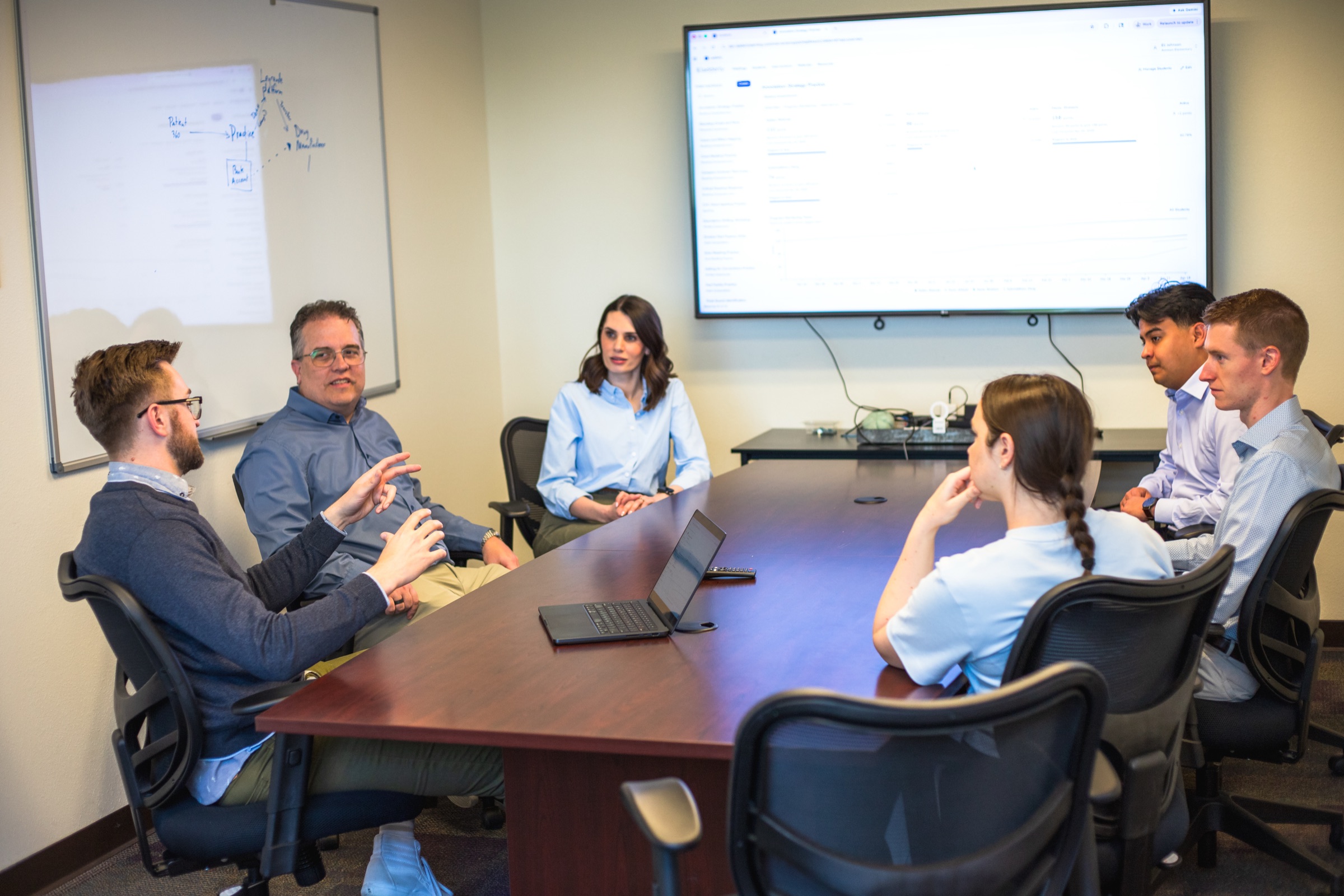 DataThink team members meeting around a conference table